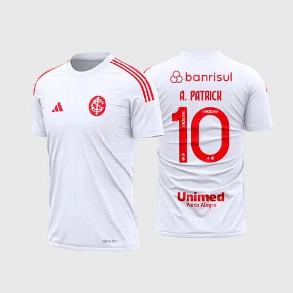 Arte Camisa Internacional Reserva 2026 - 2027.jpg apresenta o mockup do uniforme reserva do Internacional na cor branca com detalhes em vermelho nas três listras dos ombros, monograma clássico SCI, patrocínios Banrisul, Unimed Porto Alegre e layout traseiro oficial com o número 10 e nome A. Patrick para sublimação total CorelDRAW.